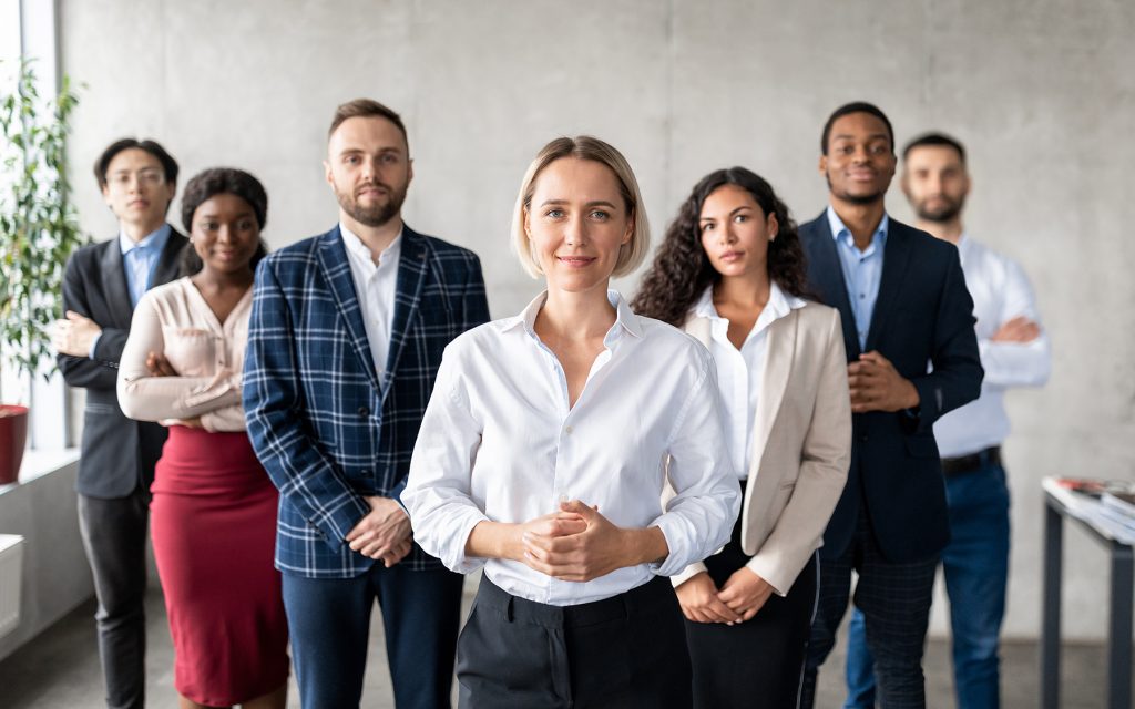 Business professional Standing In Front Of Business Team In Office
