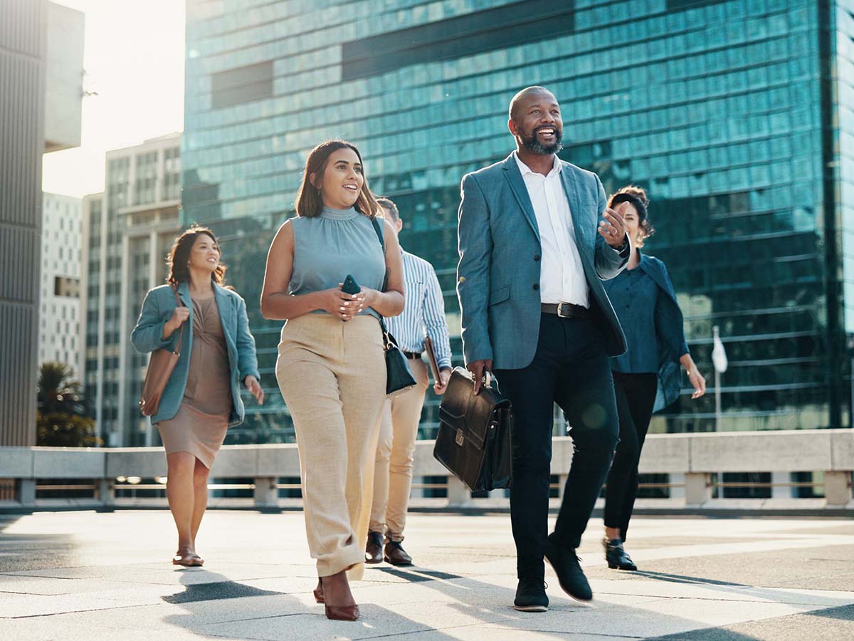 Professional, walking and happy business people in city on morning commute, travel and journey. Corporate, team of men and women in urban town for collaboration, meeting and discussion career.