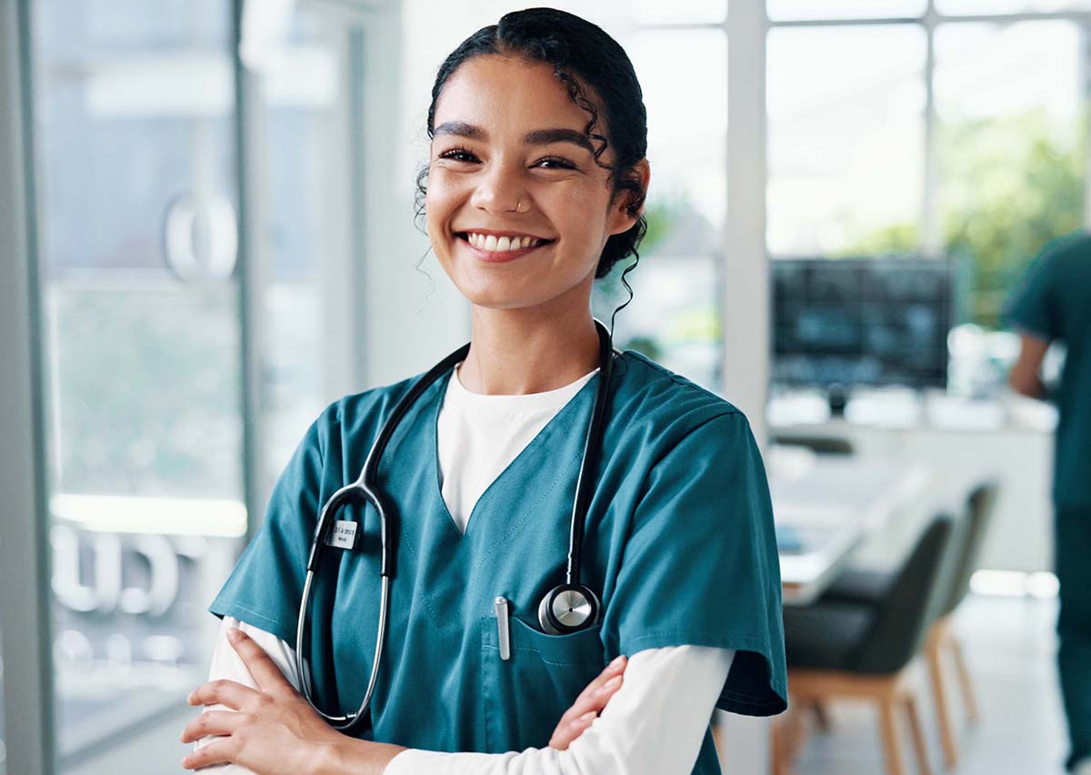 Nurse, woman or arms crossed with stethoscope at hospital for healthcare service, about us or career confidence. Medicine professional, happy doctor and portrait for health treatment and clinic care.