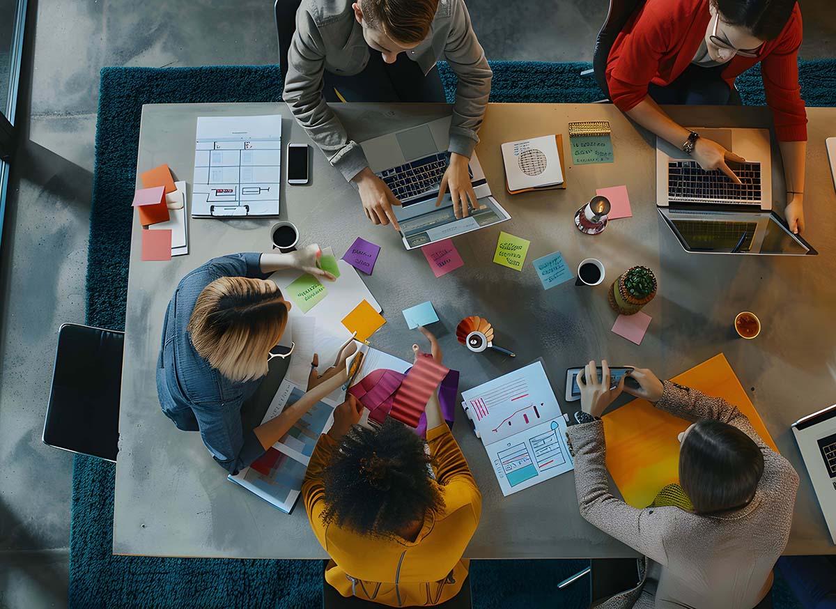Overhead view of creative agency business brain storm meeting. Team discussing roadmap to product launch, presentation, planning, strategy, new business development.