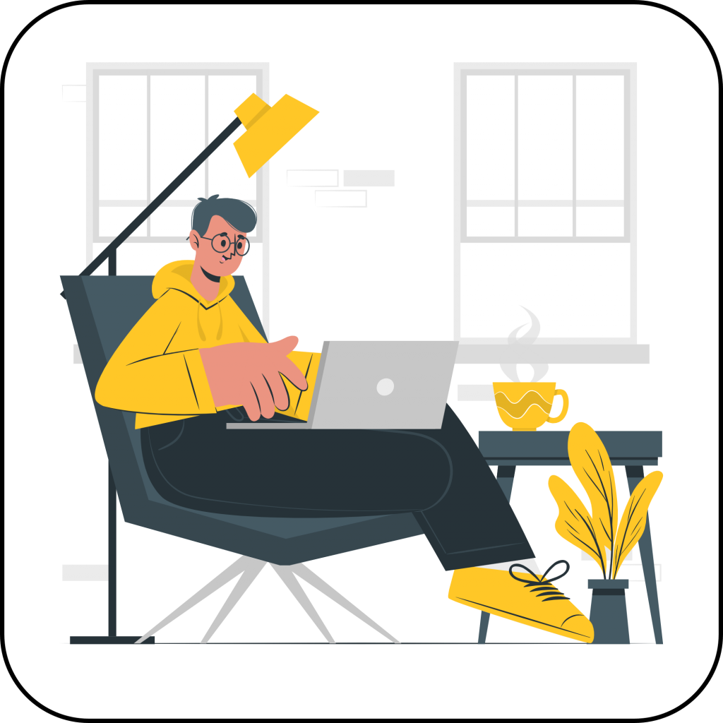 A man wearing a yellow sweatshirt and shoes, seated in a comfortable chair. He's got a laptop open on his lap, under a lamp, and in front of two windows. At his side is an end table with a hot coffee, and at his foot is a plant. 